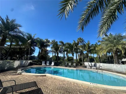 a view of a swimming pool with a table and chairs