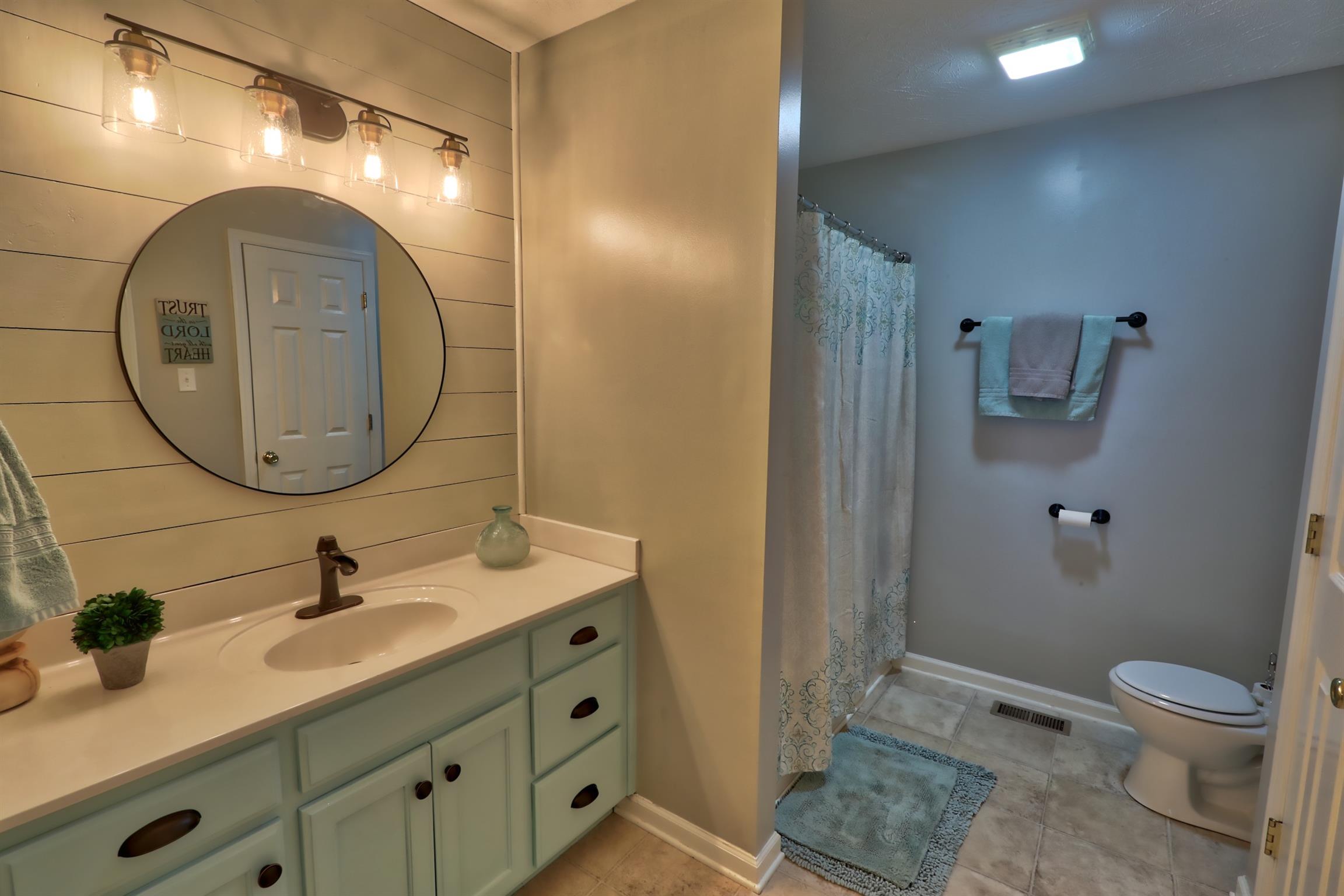 3368 Maxie Jones Road Springfield, TN 37172 - Photo 11 of 27 a bathroom with a toilet a sink and mirror
