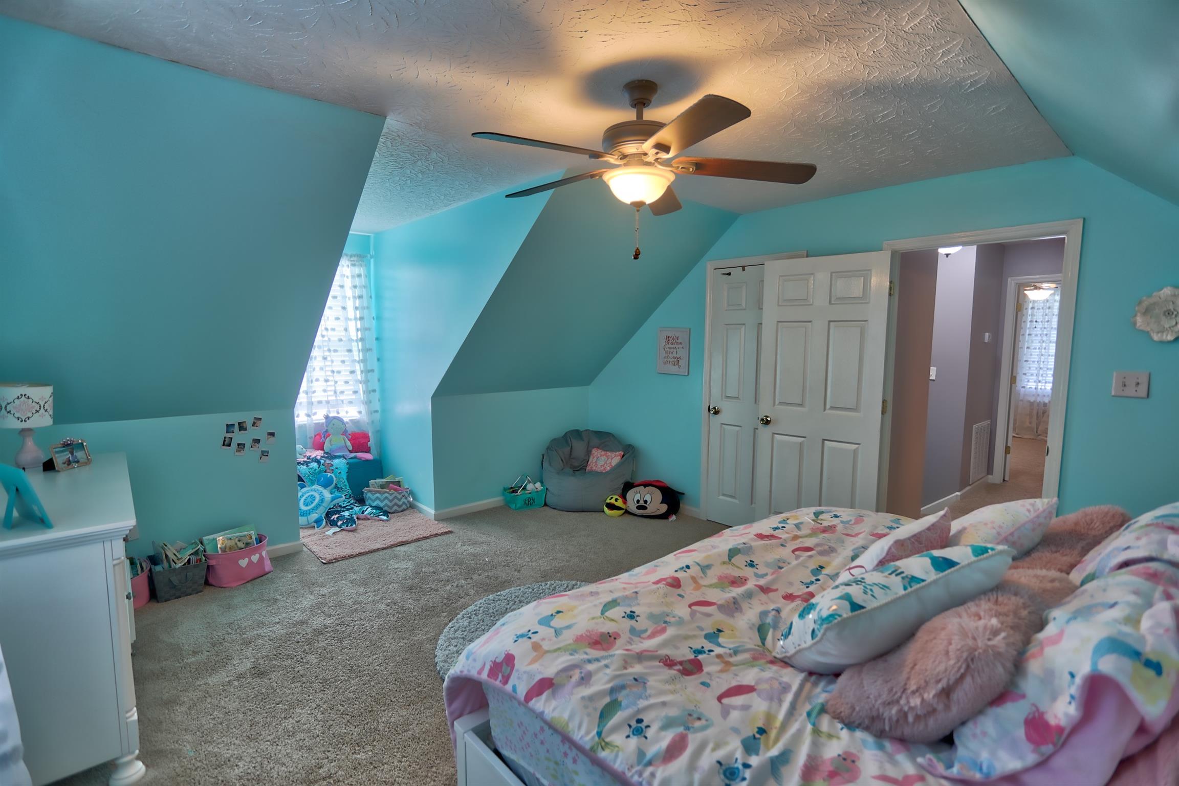 3368 Maxie Jones Road Springfield, TN 37172 - Photo 15 of 27 a bedroom with a bed and a chandelier