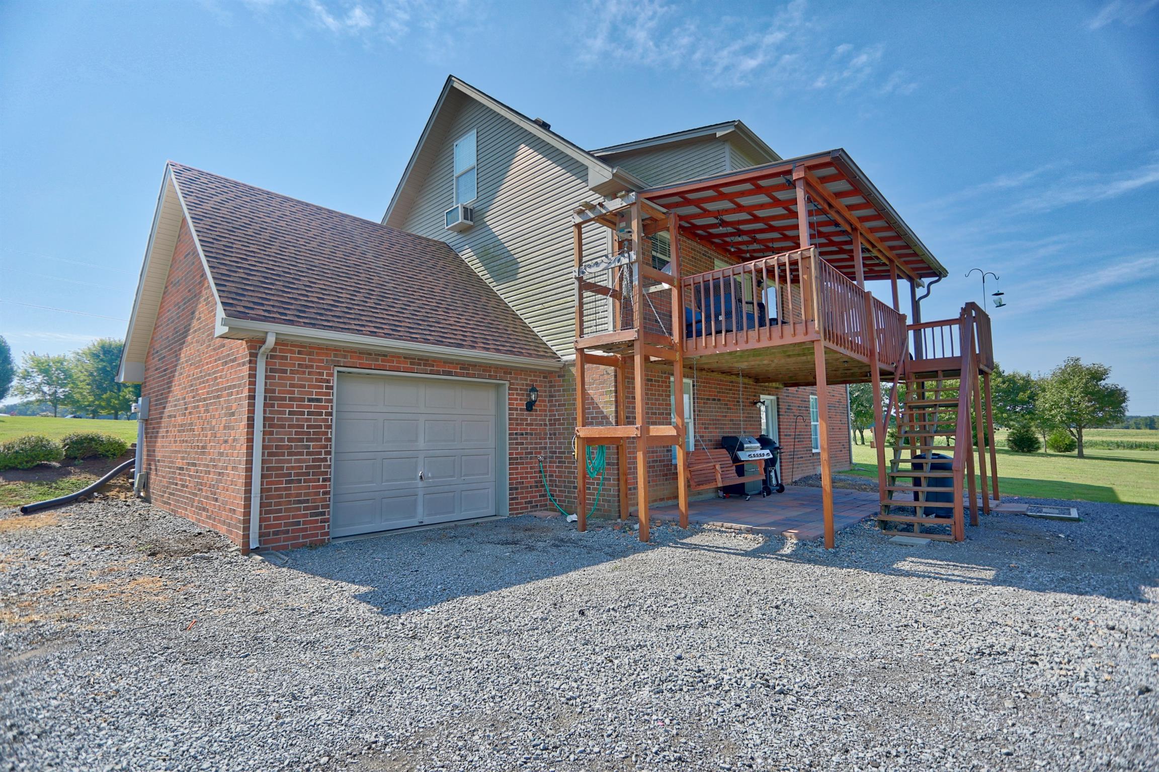 3368 Maxie Jones Road Springfield, TN 37172 - Photo 22 of 27 a view of a house with a barbeque and wooden stairs
