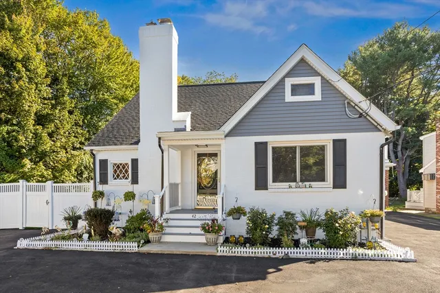 a front view of a house with a garden