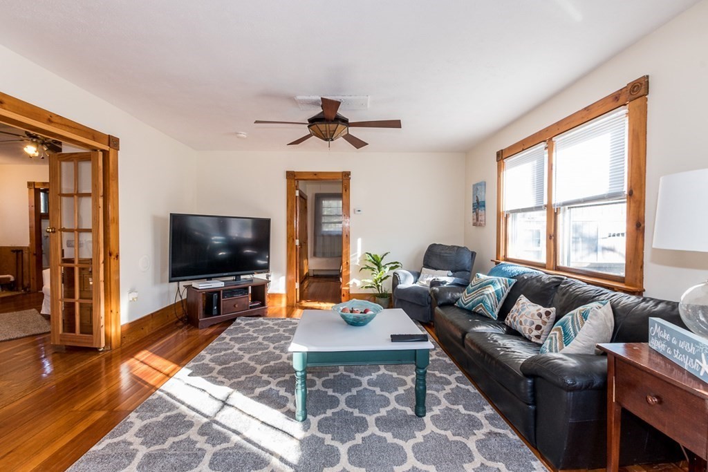 19 Cahoon Road Wareham, MA 02532 - Photo 13 of 34 a living room with furniture a flat screen tv and a large window
