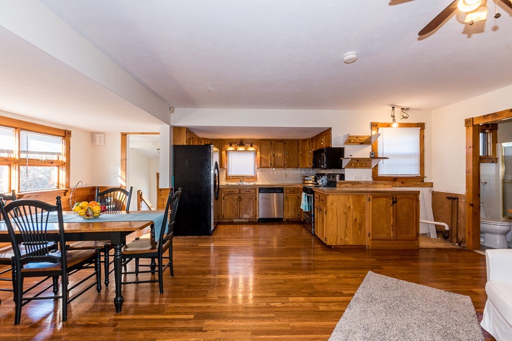 19 Cahoon Road Wareham, MA 02532 - Photo 6 of 34 a kitchen with stainless steel appliances wooden floor dining table and chairs