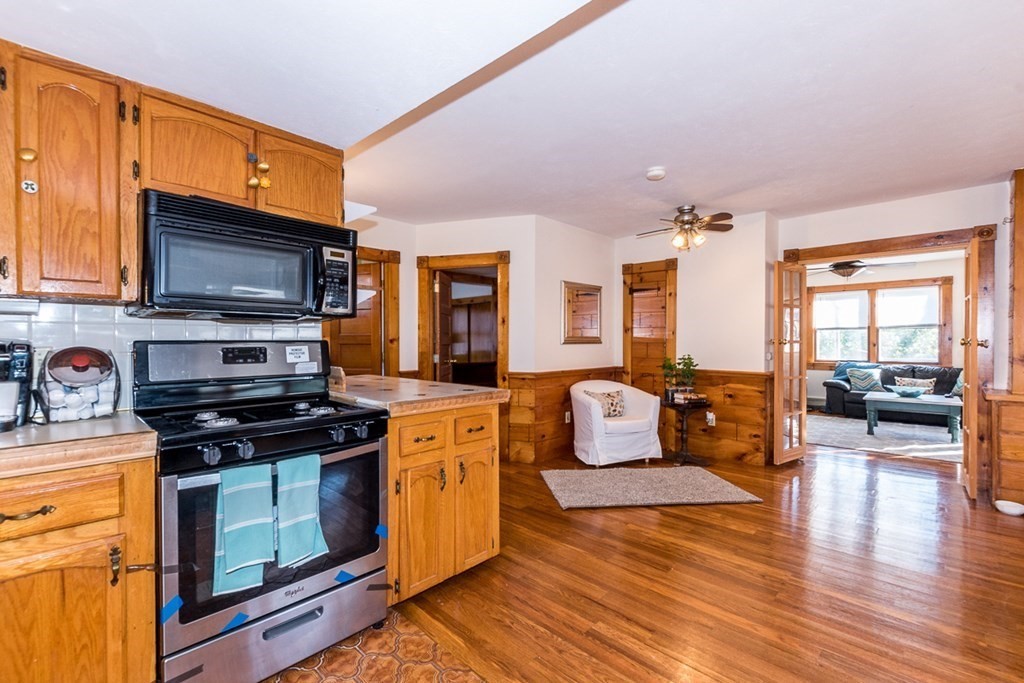 19 Cahoon Road Wareham, MA 02532 - Photo 8 of 34 a kitchen with stainless steel appliances wooden floors and wooden cabinets