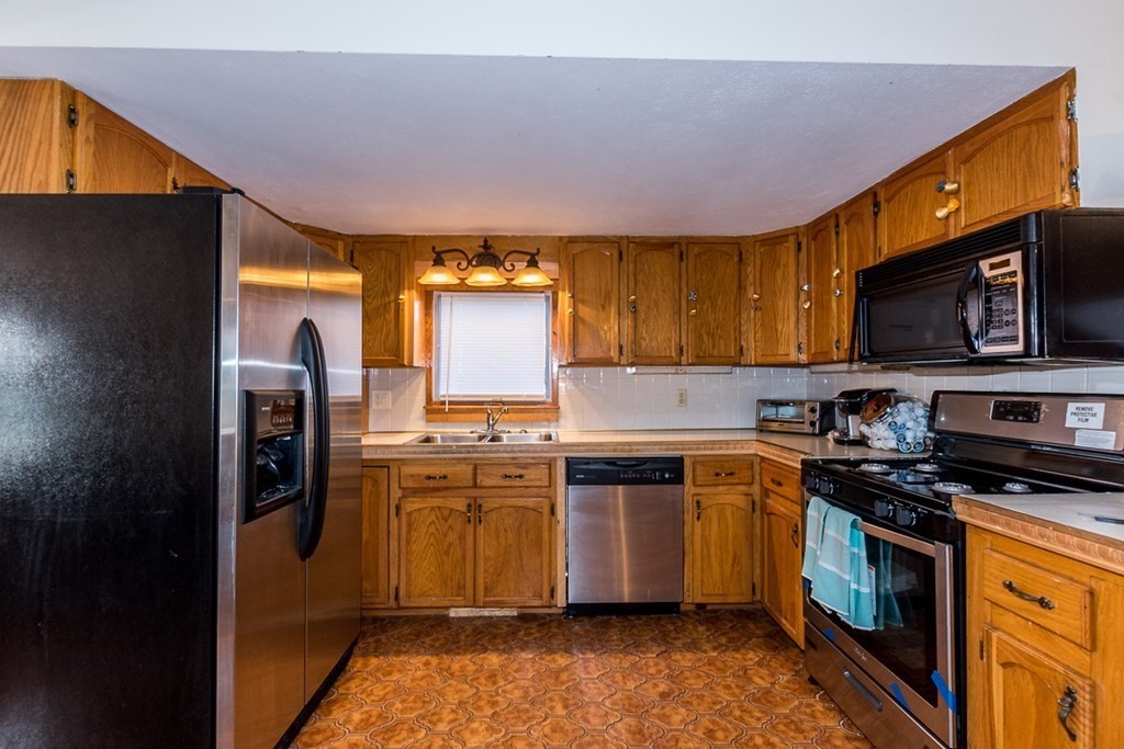 19 Cahoon Road Wareham, MA 02532 - Photo 9 of 34 a kitchen with stainless steel appliances granite countertop a stove a sink dishwasher a refrigerator and a microwave