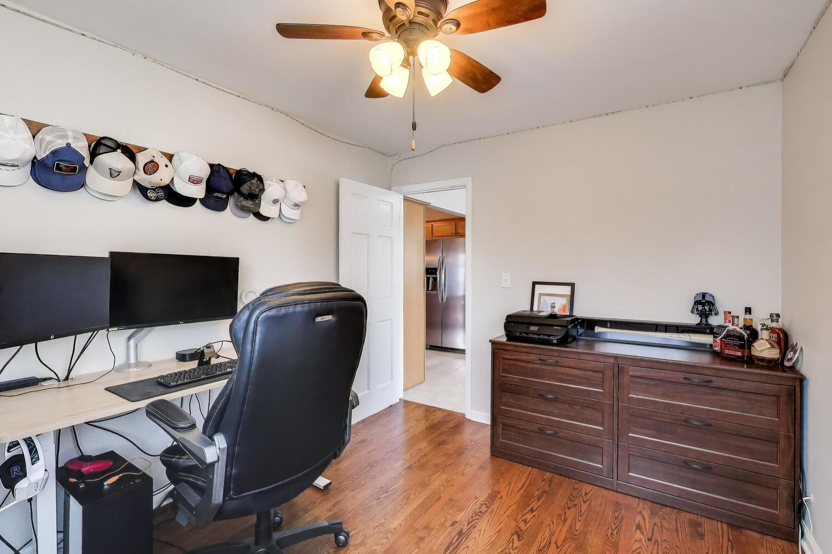 906 Hickory Lane Naperville, IL 60540 - Photo 13 of 30 a room with a chandelier and a flat screen tv
