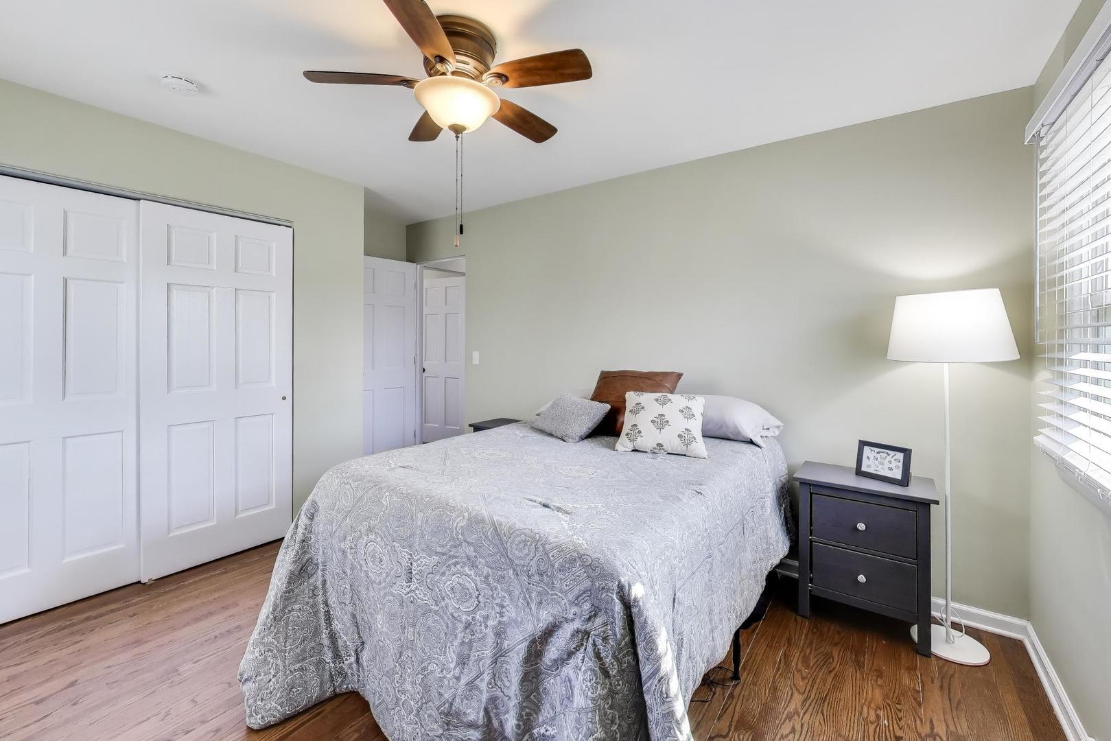 906 Hickory Lane Naperville, IL 60540 - Photo 16 of 30 a bedroom with a bed and wooden floor