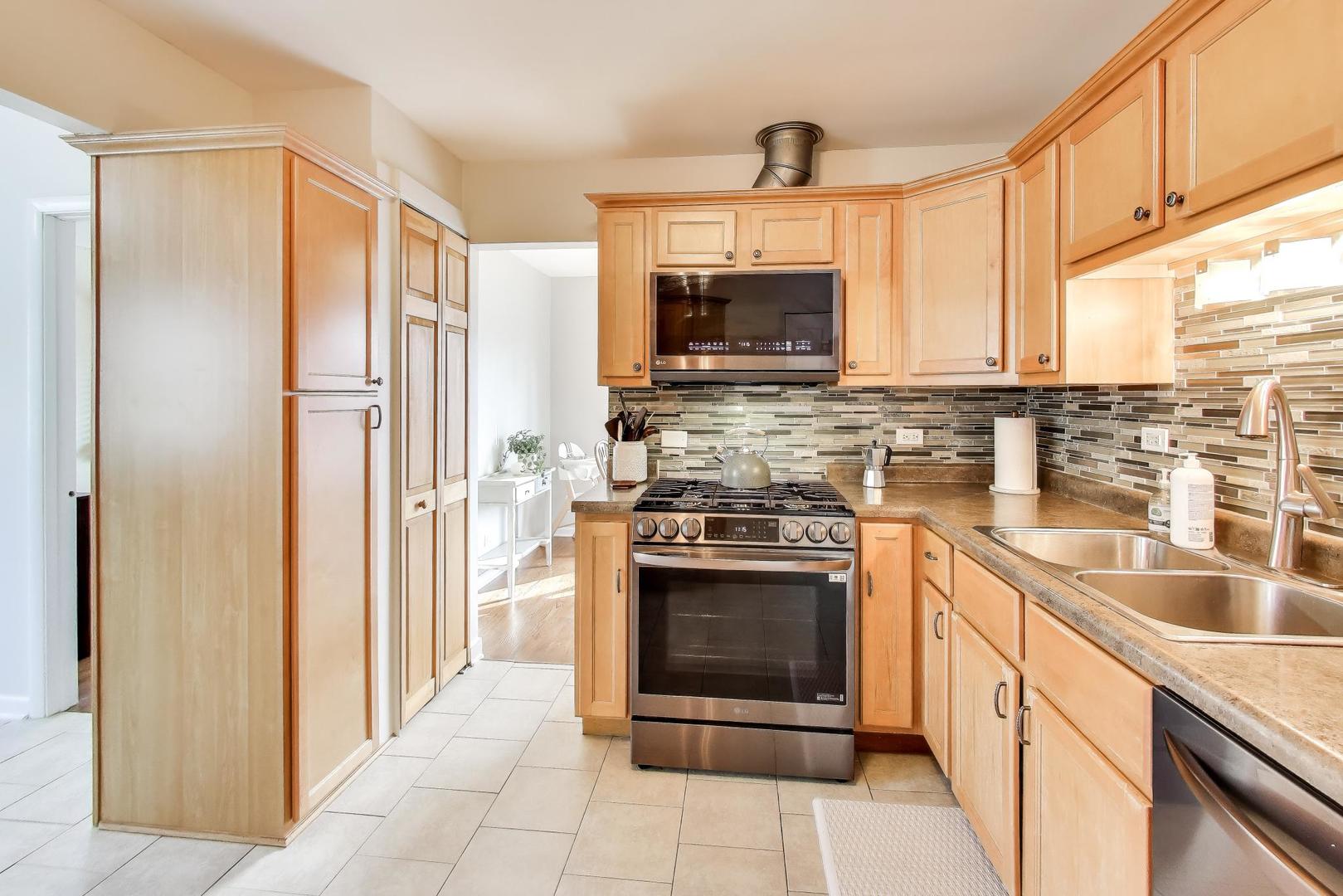 906 Hickory Lane Naperville, IL 60540 - Photo 9 of 30 a kitchen with stainless steel appliances granite countertop a refrigerator and a sink