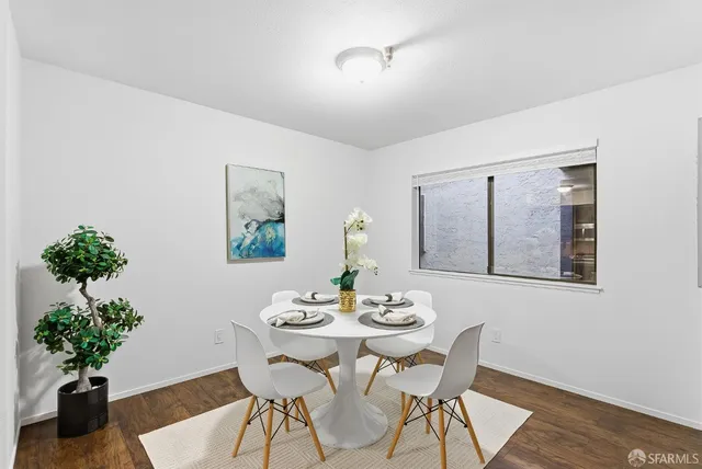 a dining room with furniture and a floor to ceiling window
