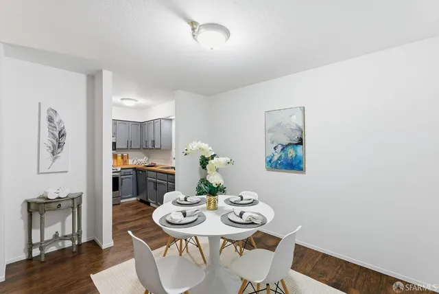 a view of a dining room with furniture kitchen and wooden floor