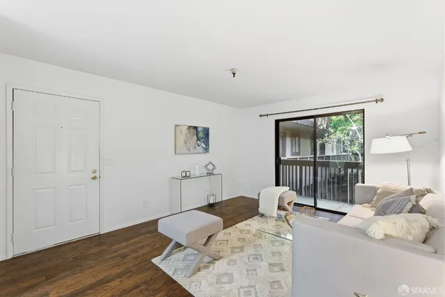 a view of a dining room with furniture wooden floor and a potted plant