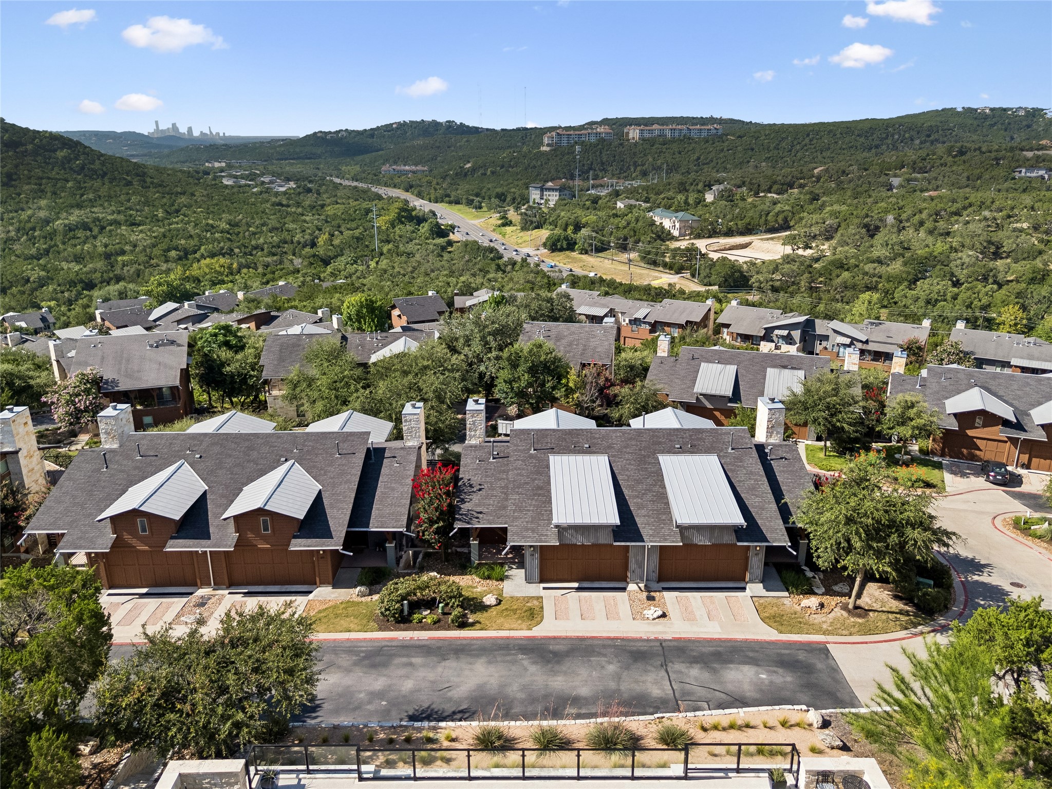 8110 Ranch Road 2222, Unit 68 Austin, TX 78730 - Photo 17 of 24 Perched on a hillside, this dwelling offers striking views of the distant cityscape and surrounding natural expanse.