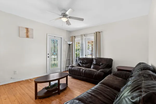 a living room with furniture and wooden floor