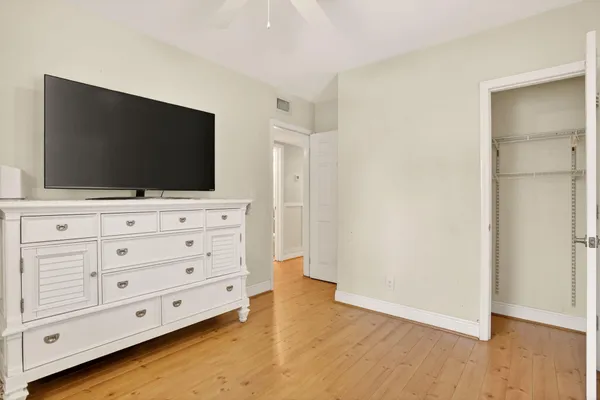 an empty room with wooden floor and a window