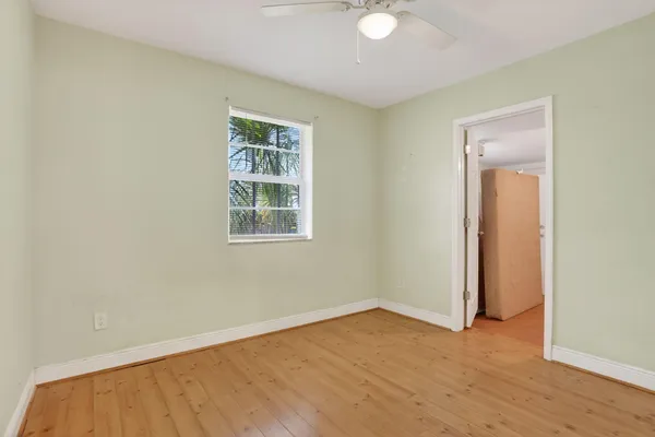 a view of a room with wooden floor and a bathroom