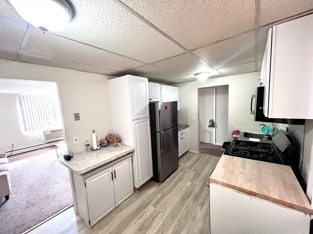 a kitchen with a refrigerator and a sink
