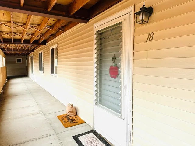 a living room with furniture a flat screen tv and a large window
