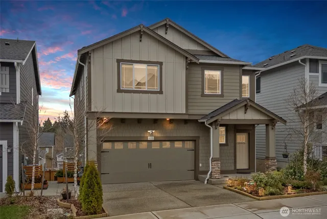 a front view of a house with garage