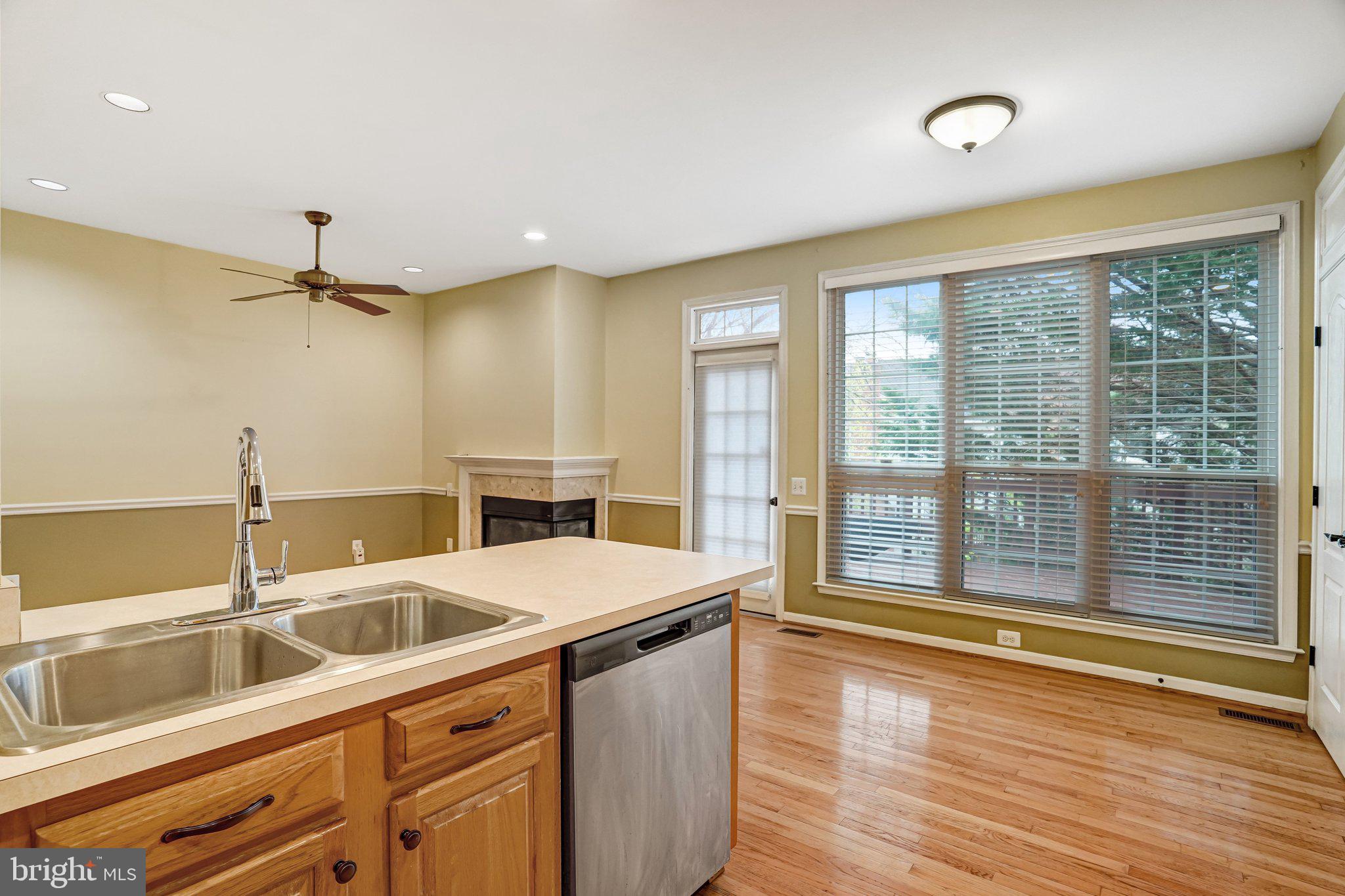 20927 Trinity Square Sterling, VA 20165 - Photo 11 of 47 a view of a kitchen with a sink and wooden floor