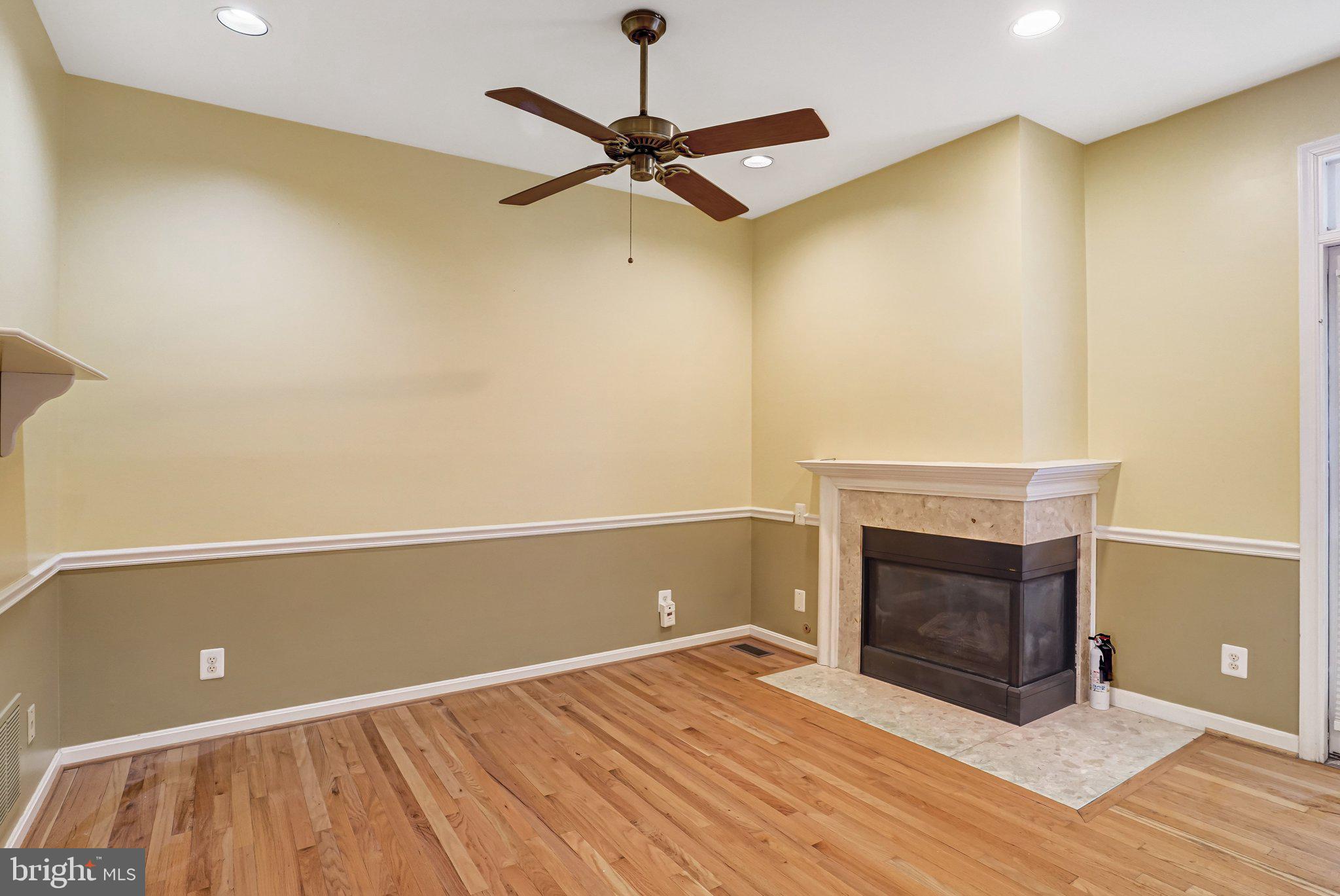 20927 Trinity Square Sterling, VA 20165 - Photo 13 of 47 a view of empty room with wooden floor and fireplace