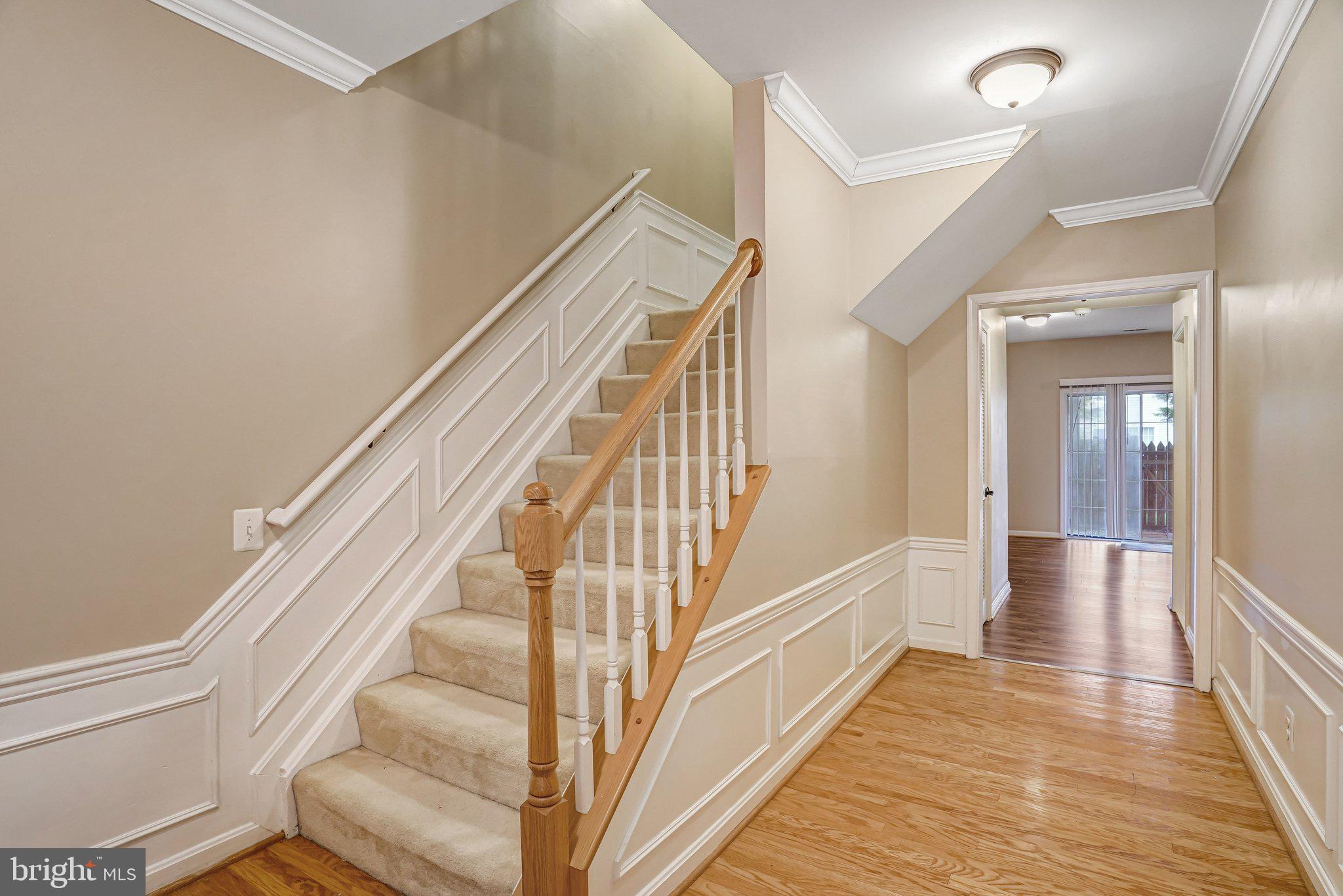 20927 Trinity Square Sterling, VA 20165 - Photo 2 of 47 a view of a hallway with wooden floor and staircase