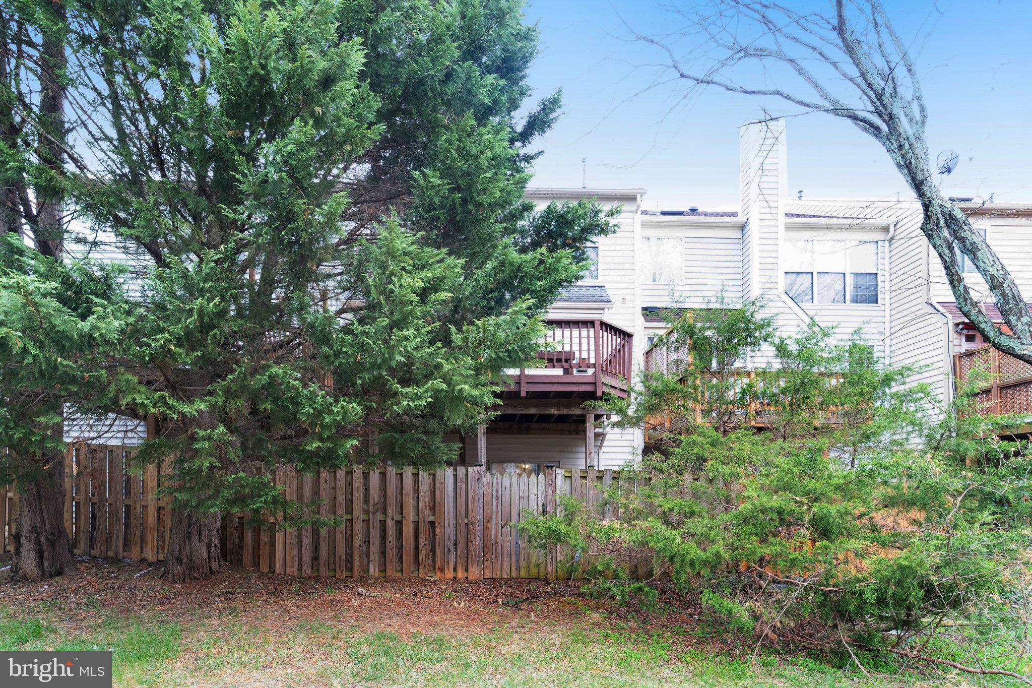 20927 Trinity Square Sterling, VA 20165 - Photo 37 of 47 a view of a house with a small yard and wooden fence