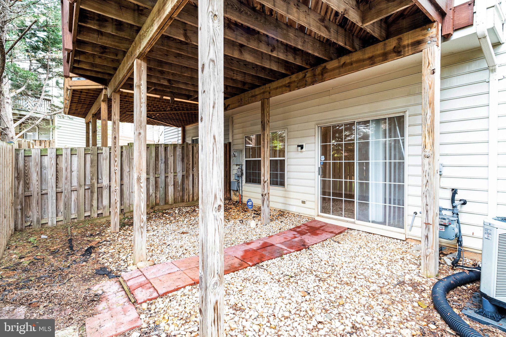 20927 Trinity Square Sterling, VA 20165 - Photo 38 of 47 a view of a porch with a table and chairs and wooden fence