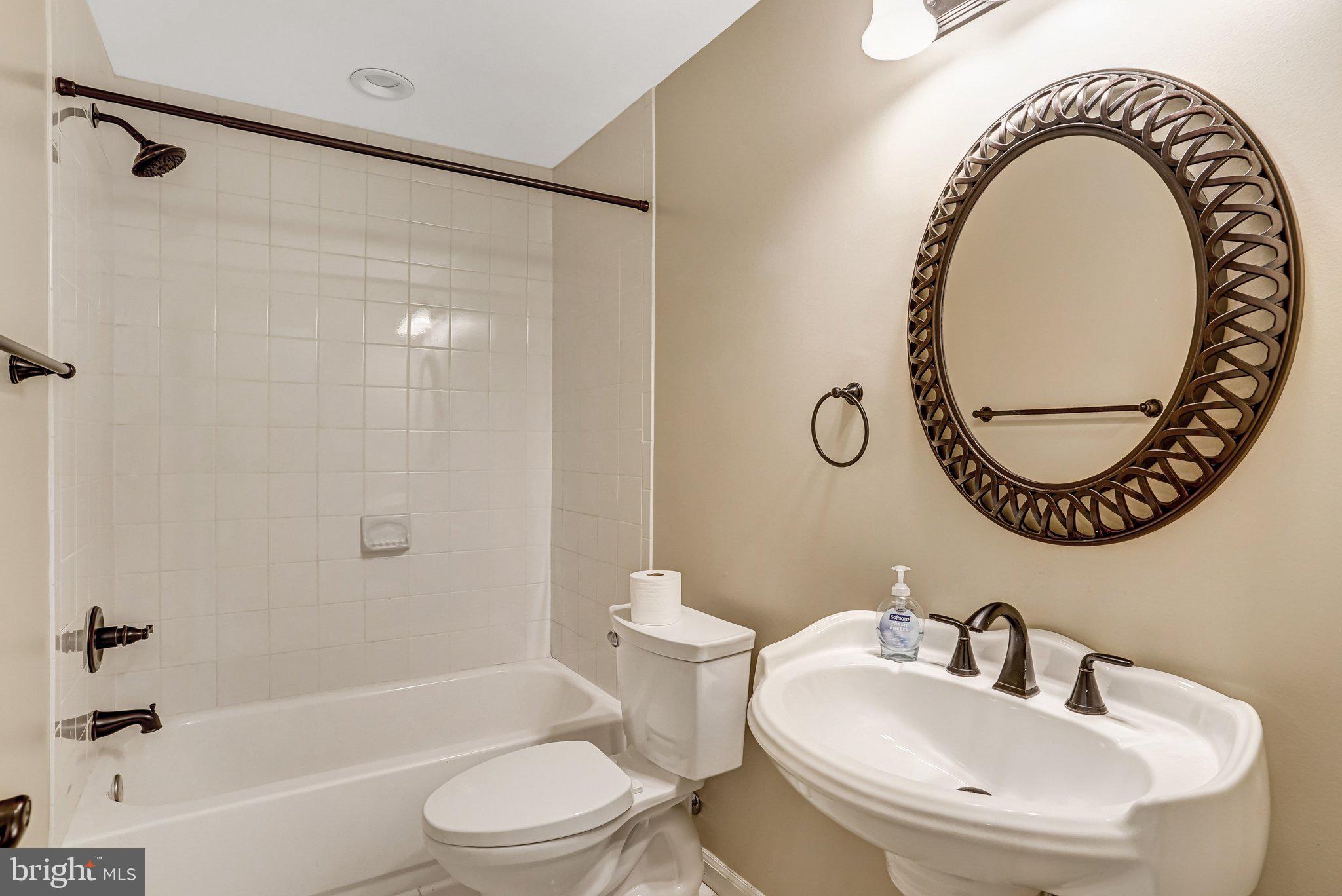 20927 Trinity Square Sterling, VA 20165 - Photo 4 of 47 a bathroom with a sink and a mirror
