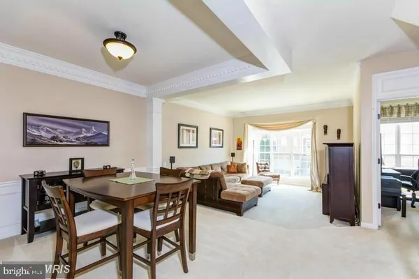 a view of a dining room with furniture and a window