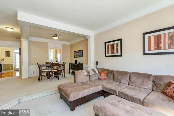 a living room with furniture and a dining table