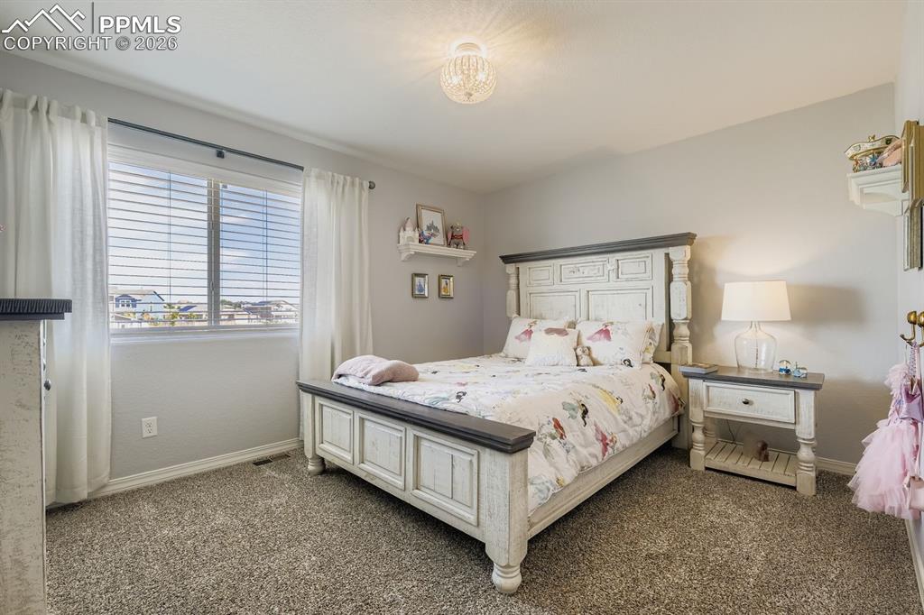 11329 Avena Road Peyton, CO 80831 - Photo 17 of 42 a bedroom with a bed and a window