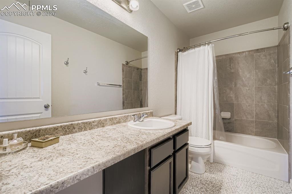 11329 Avena Road Peyton, CO 80831 - Photo 18 of 42 a bathroom with a granite countertop bathtub sink and toilet