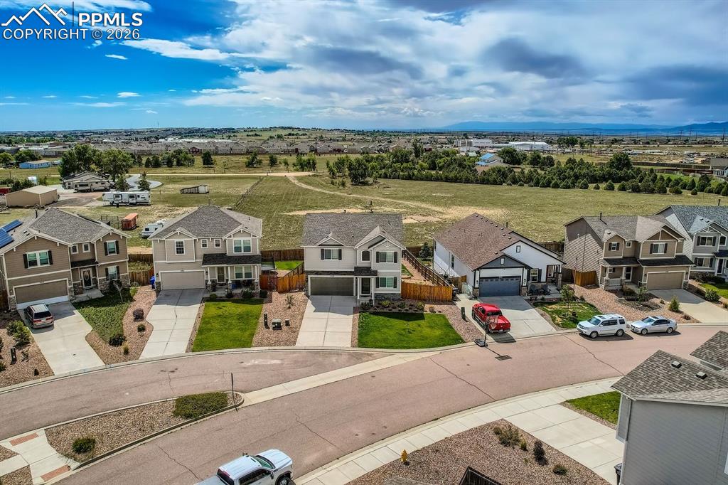 11329 Avena Road Peyton, CO 80831 - Photo 29 of 42 an aerial view of a building with garden space and houses