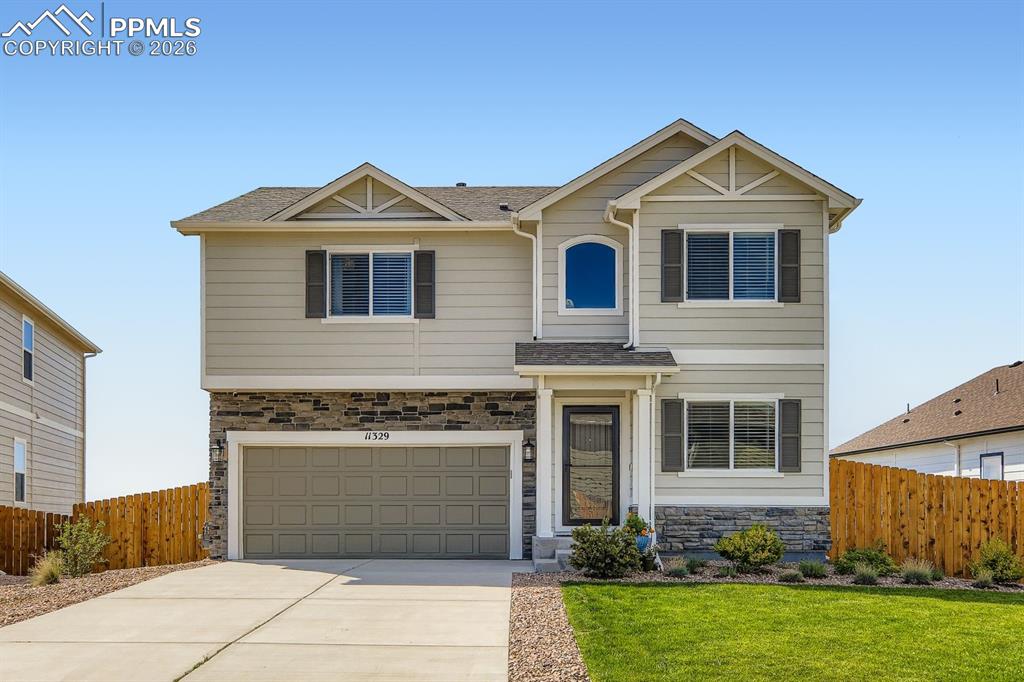 11329 Avena Road Peyton, CO 80831 - Photo 33 of 42 a front view of a house with garden