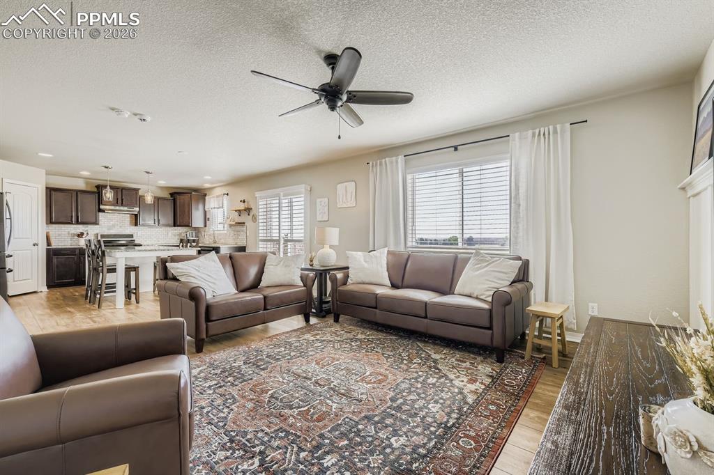 11329 Avena Road Peyton, CO 80831 - Photo 4 of 42 a living room with furniture and a wooden floor