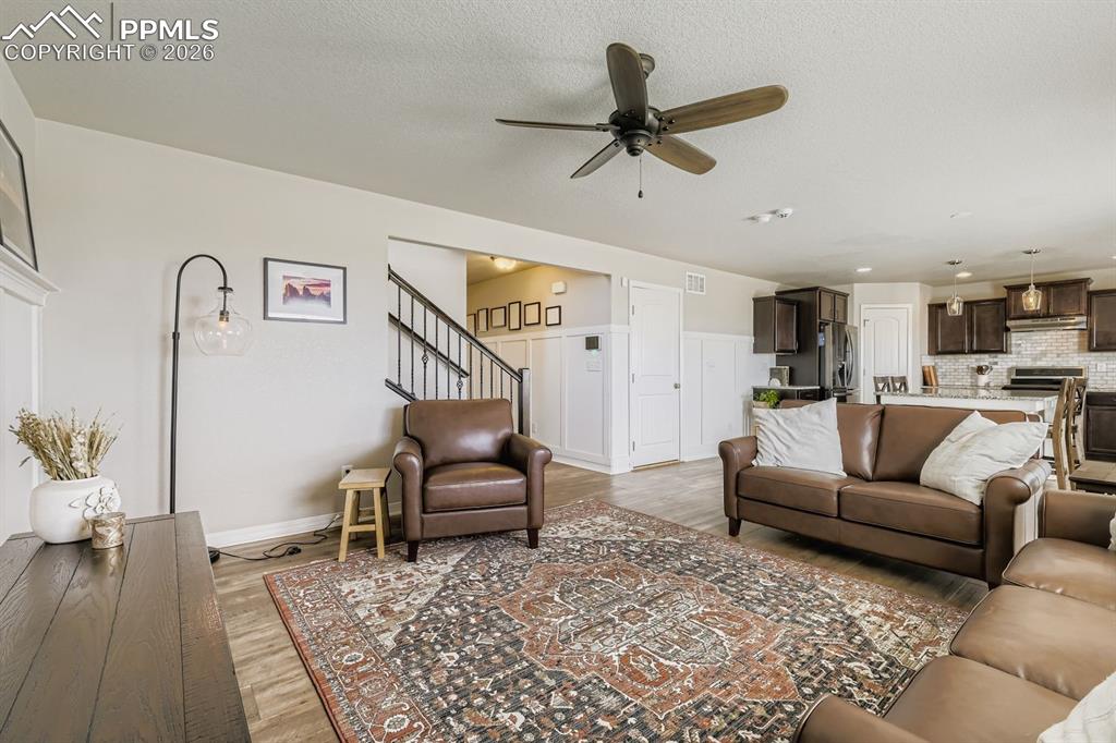 11329 Avena Road Peyton, CO 80831 - Photo 6 of 42 a living room with furniture and a wooden floor
