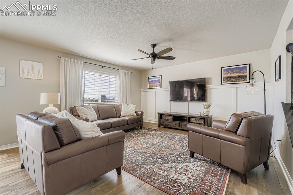 11329 Avena Road Peyton, CO 80831 - Photo 7 of 42 a living room with furniture and a flat screen tv