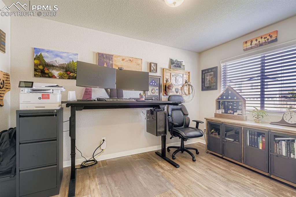 11329 Avena Road Peyton, CO 80831 - Photo 9 of 42 a view of a workspace with furniture and a window