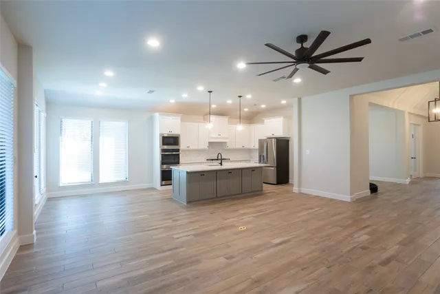 a view of a kitchen with a sink and a window