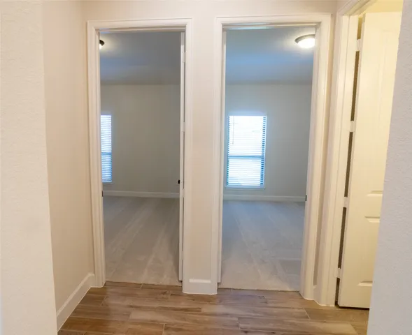 a view of a bathroom from a corridor