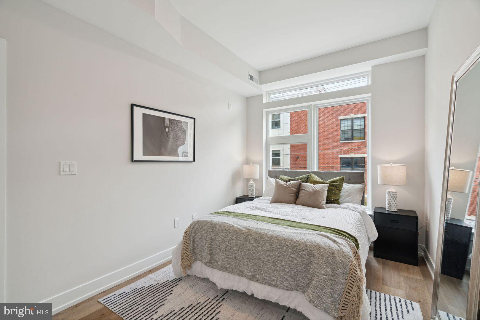 720 West Thompson Street, Unit 1B208 Philadelphia, PA 19122 - Photo 16 of 32 a bedroom with a bed and a window