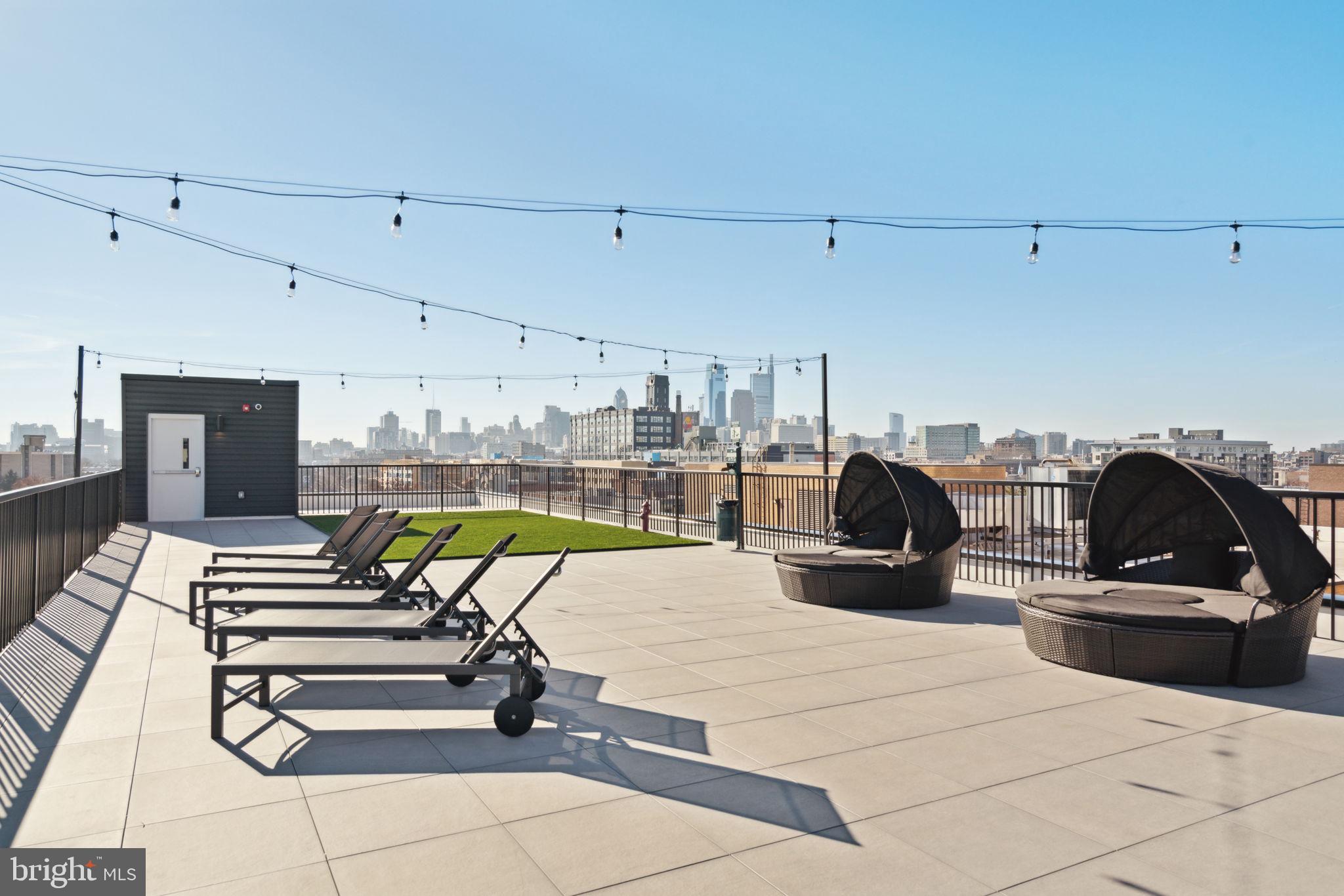 720 West Thompson Street, Unit 1B208 Philadelphia, PA 19122 - Photo 28 of 32 a view of a kitchen with kitchen island a stove a chimney and a faucet