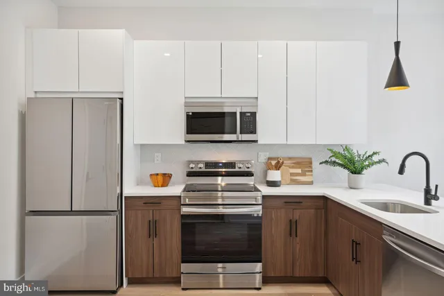 a kitchen with a sink a stove and refrigerator