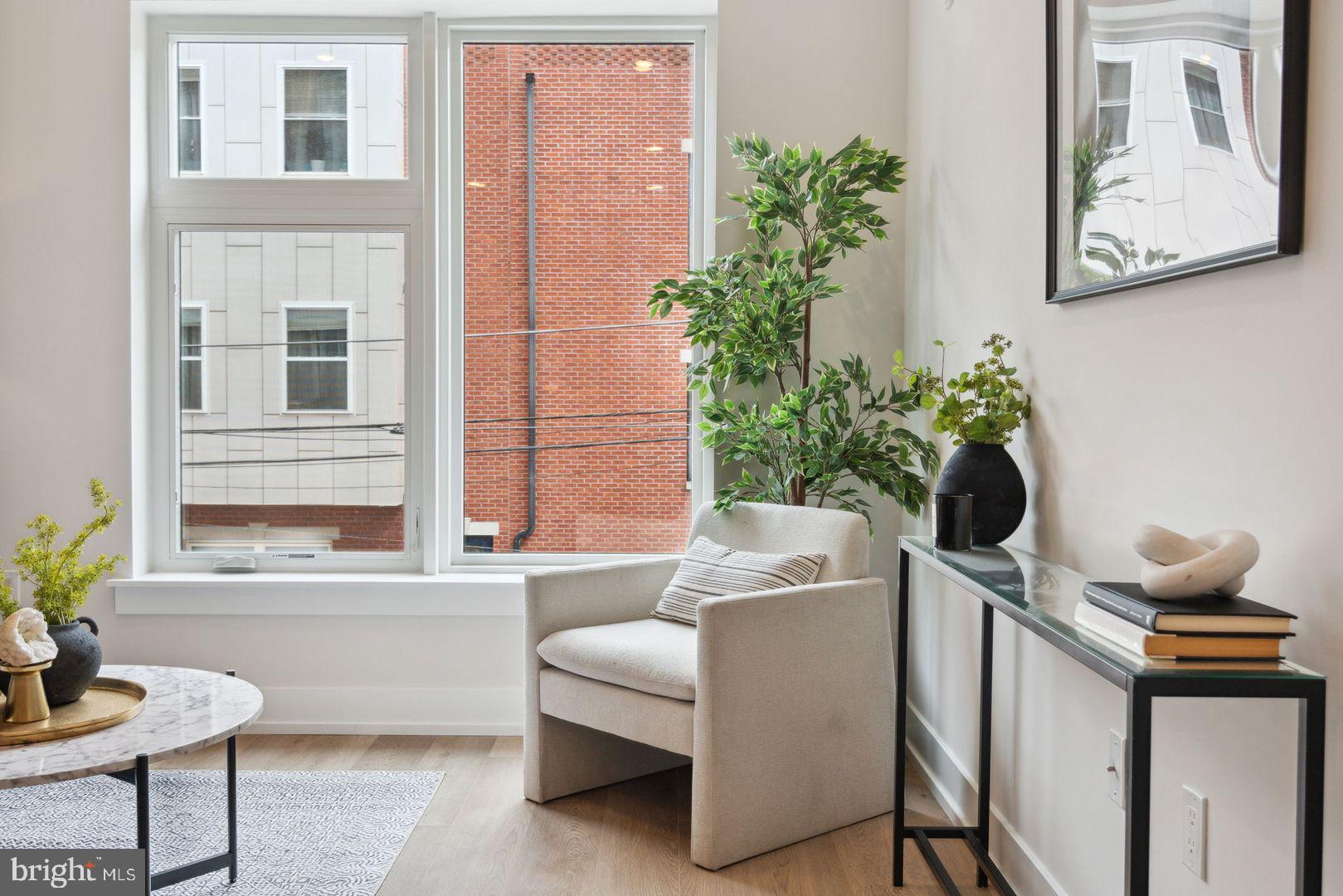 720 West Thompson Street, Unit 1B208 Philadelphia, PA 19122 - Photo 7 of 32 a living room with furniture and flowers