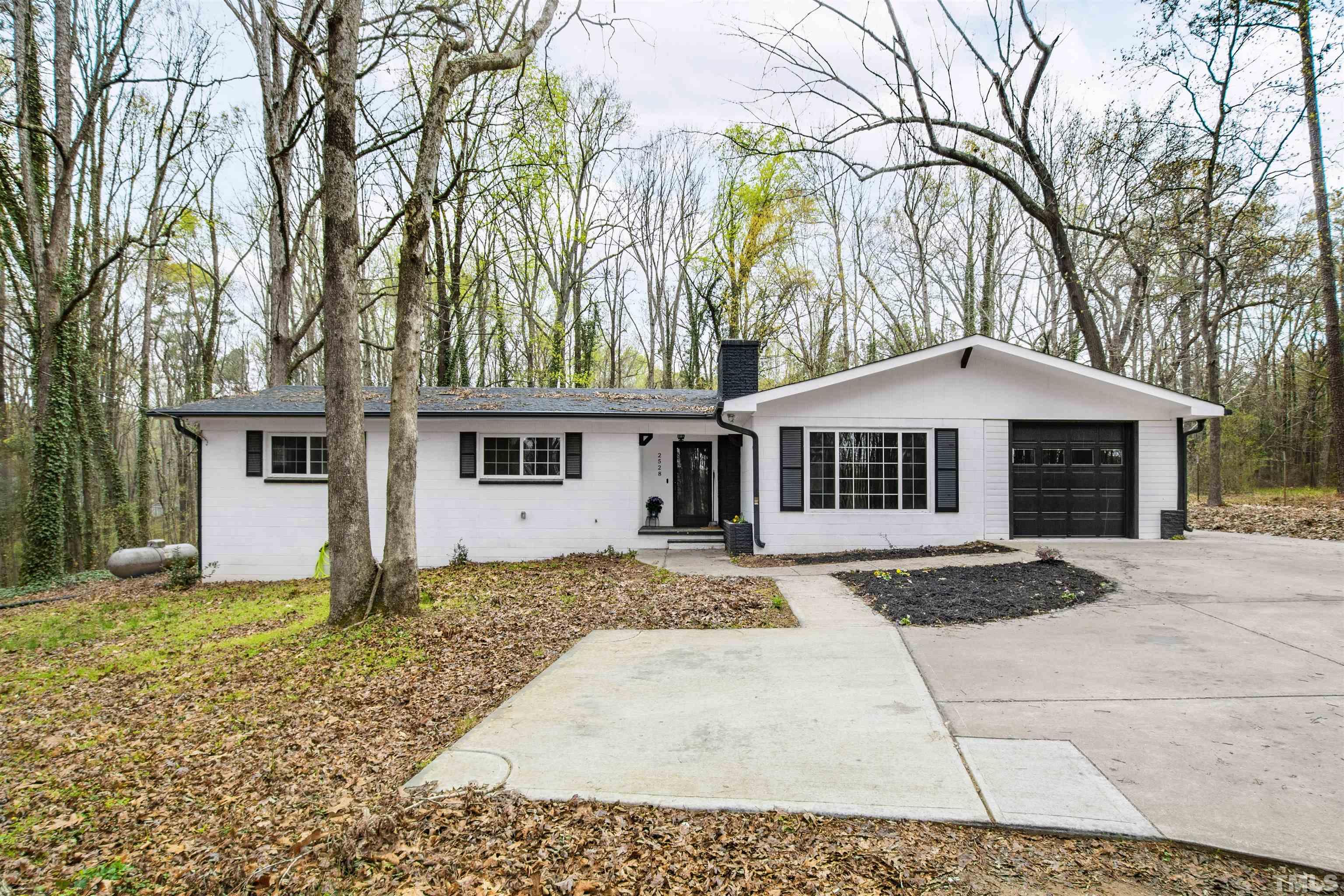 2528 Optimist Farm Road Apex, NC 27539 - Photo 1 of 49 a front view of a house with a yard and garage