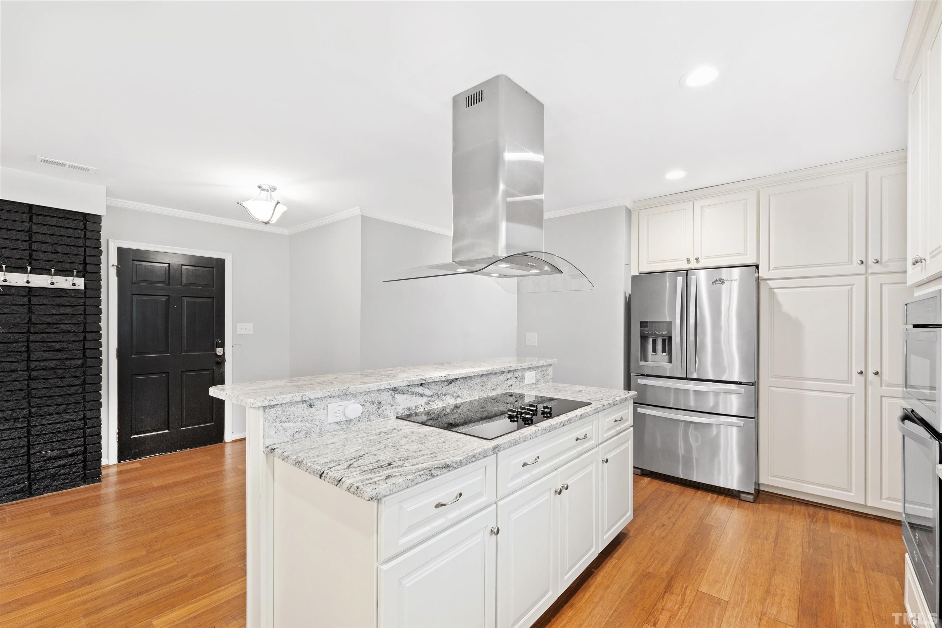 2528 Optimist Farm Road Apex, NC 27539 - Photo 13 of 49 a kitchen with granite countertop a refrigerator oven a sink and white cabinets