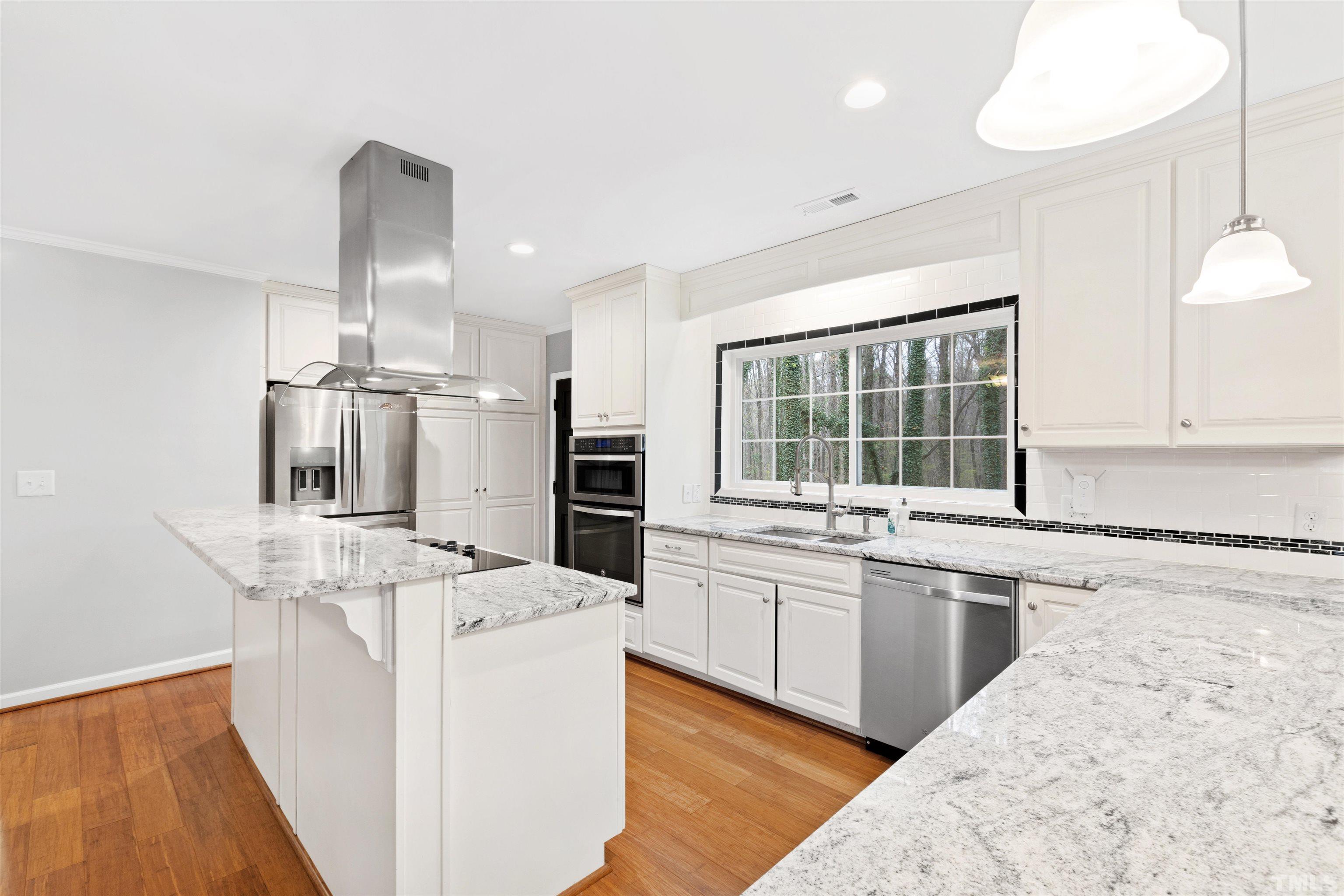 2528 Optimist Farm Road Apex, NC 27539 - Photo 16 of 49 a kitchen with stainless steel appliances kitchen island granite countertop a sink stove and refrigerator