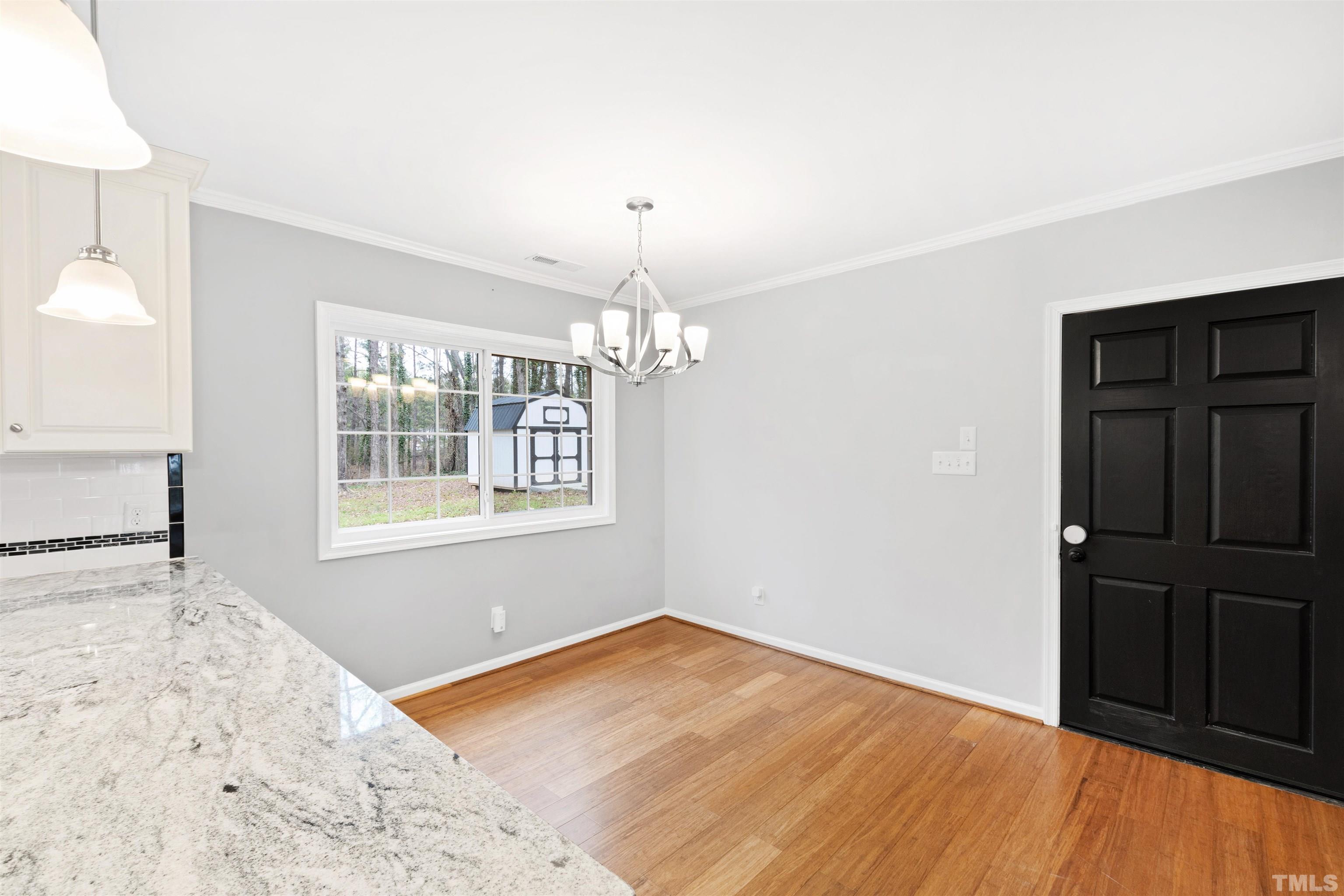 2528 Optimist Farm Road Apex, NC 27539 - Photo 22 of 49 wooden floor in an empty room with a window