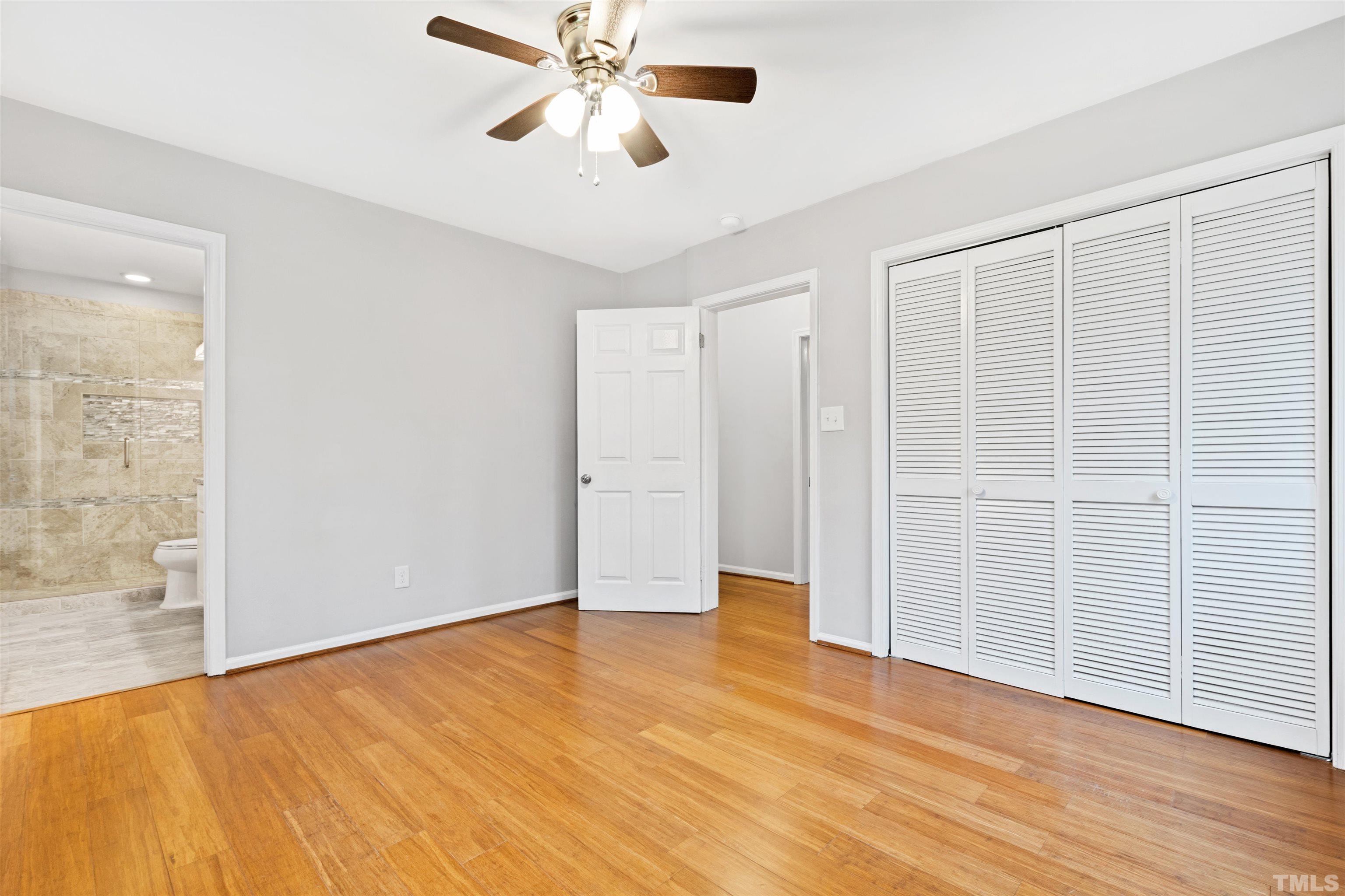 2528 Optimist Farm Road Apex, NC 27539 - Photo 25 of 49 an empty room with wooden floor closet and windows
