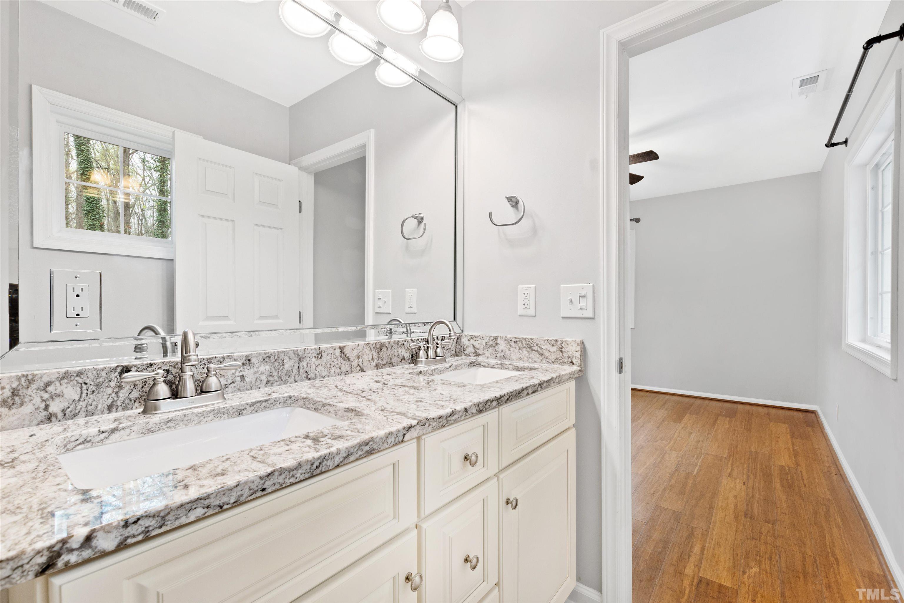 2528 Optimist Farm Road Apex, NC 27539 - Photo 29 of 49 a bathroom with a granite countertop sink mirror and double